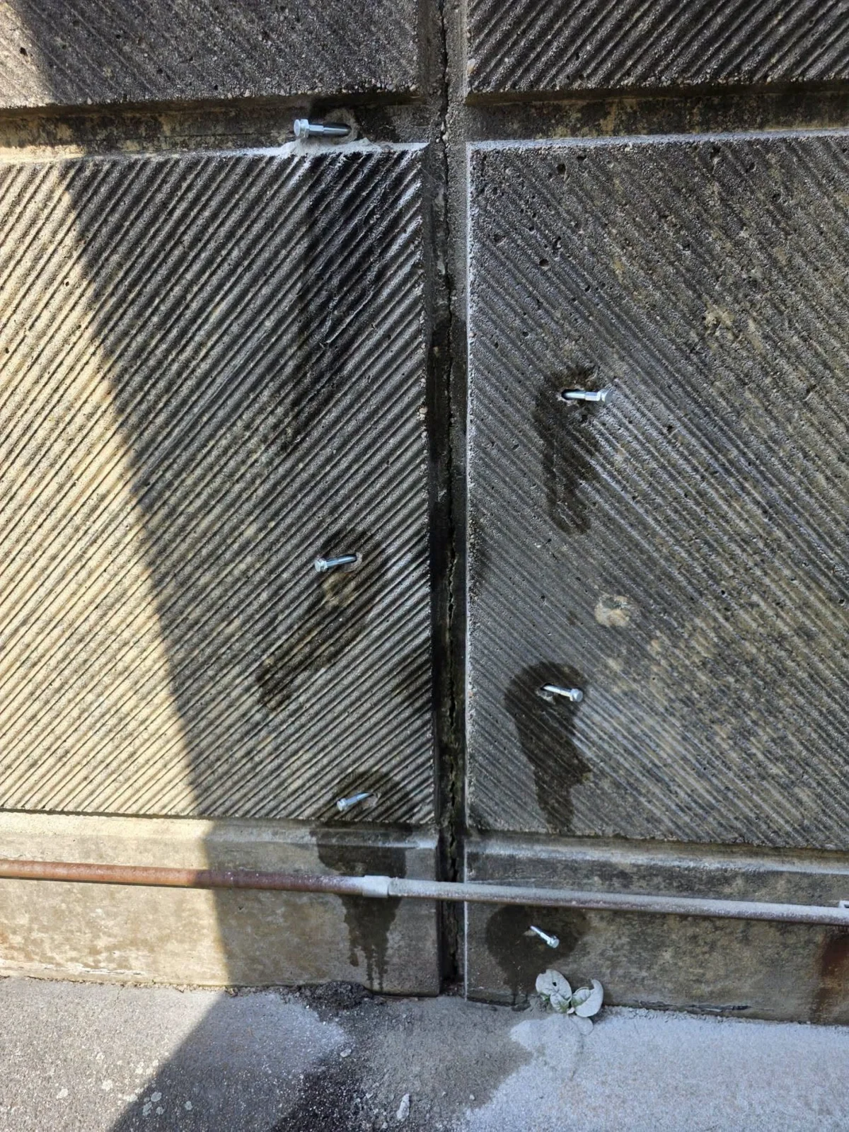Crack repair ports on a grooved concrete aeration tank wall