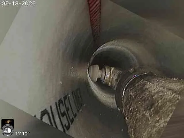 Robotic cutting equipment at a service connection inside a lined pipe