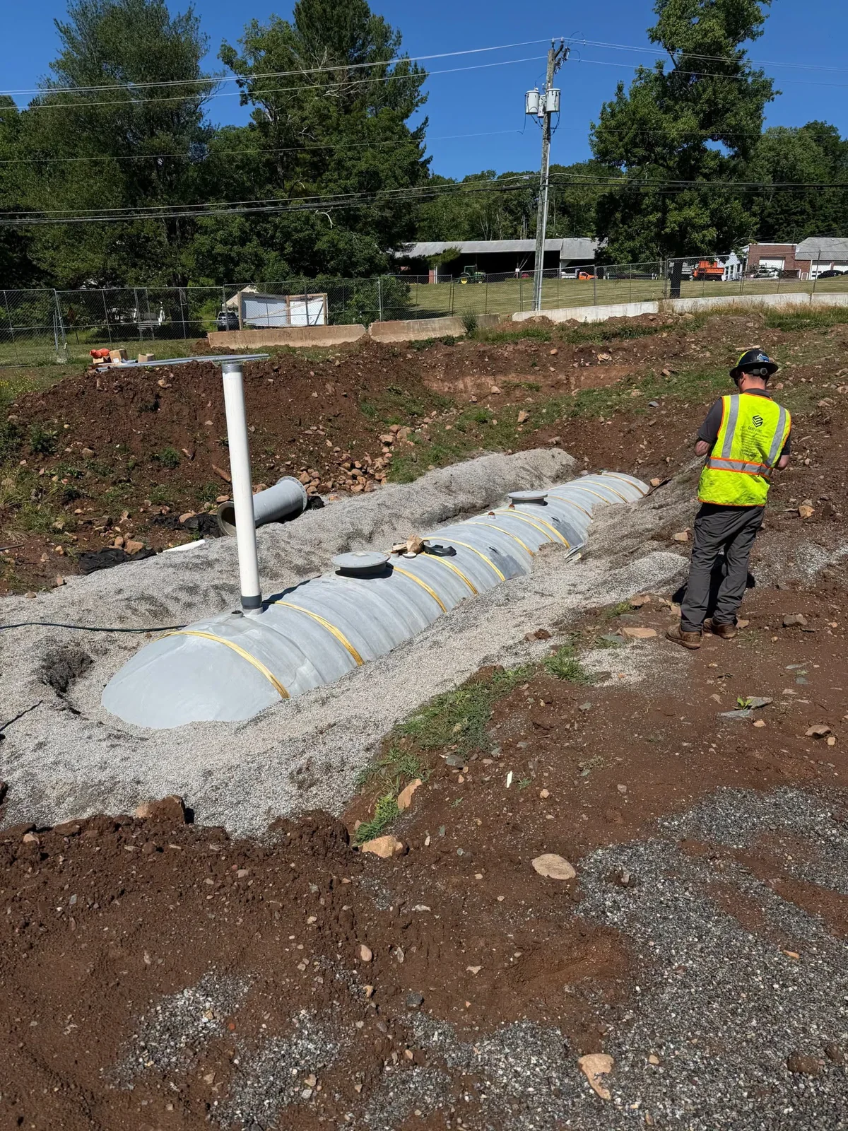 Crew member beside an exposed fresh water suppression tank