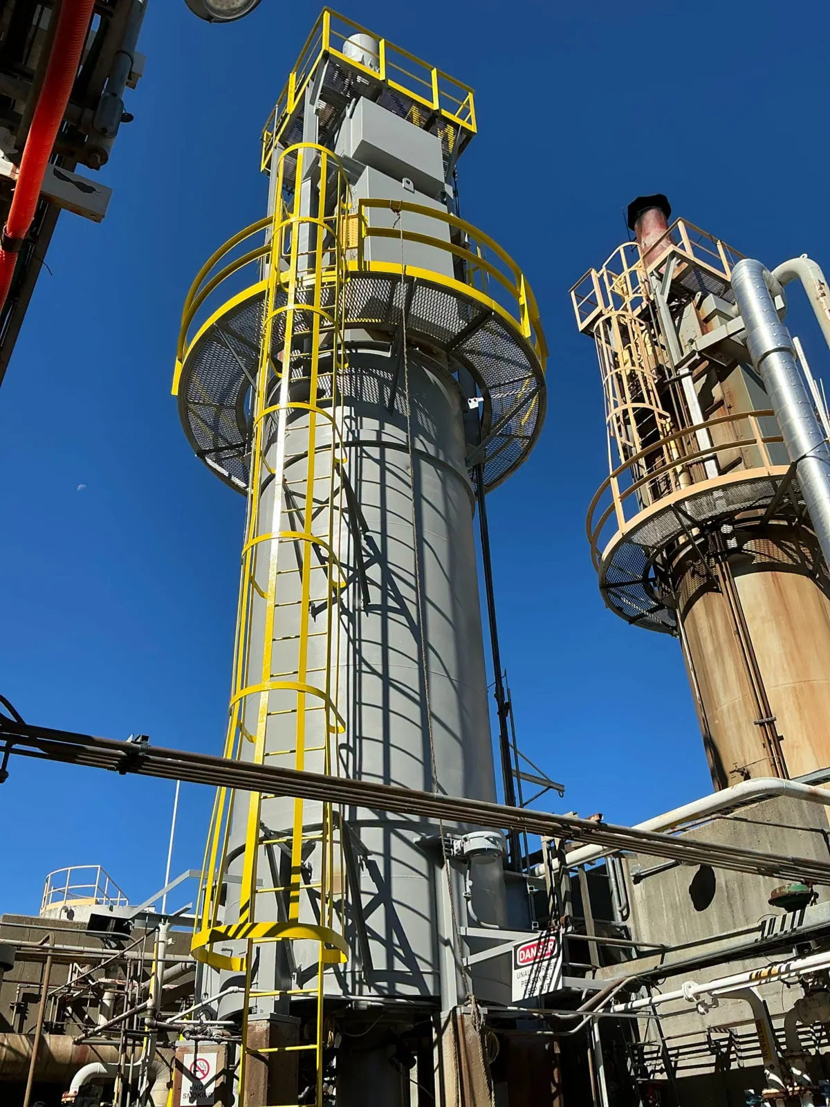 Coated industrial vessels with ladders and access platforms