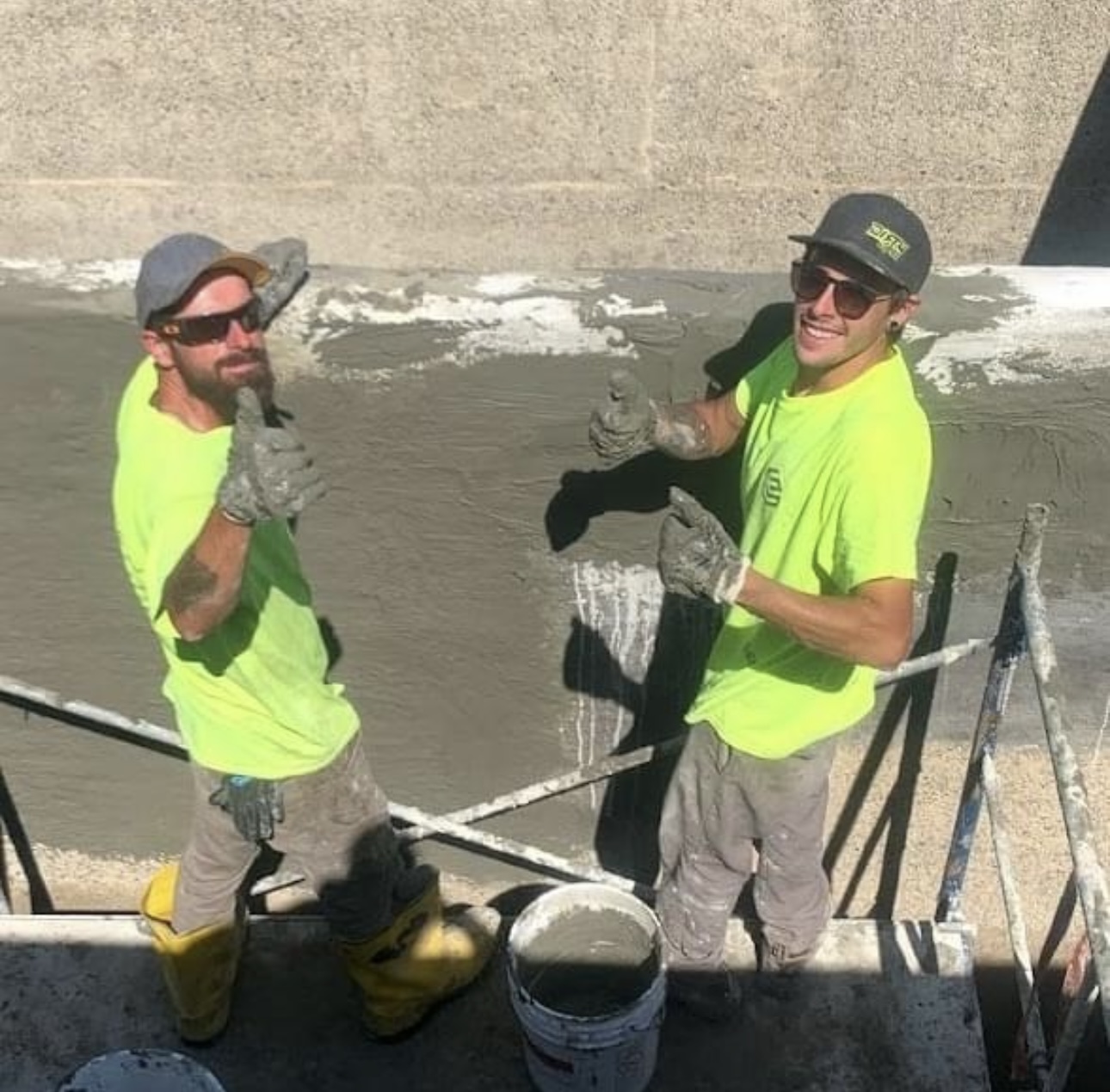 Savy & Sons crew members finishing concrete work on a seawall