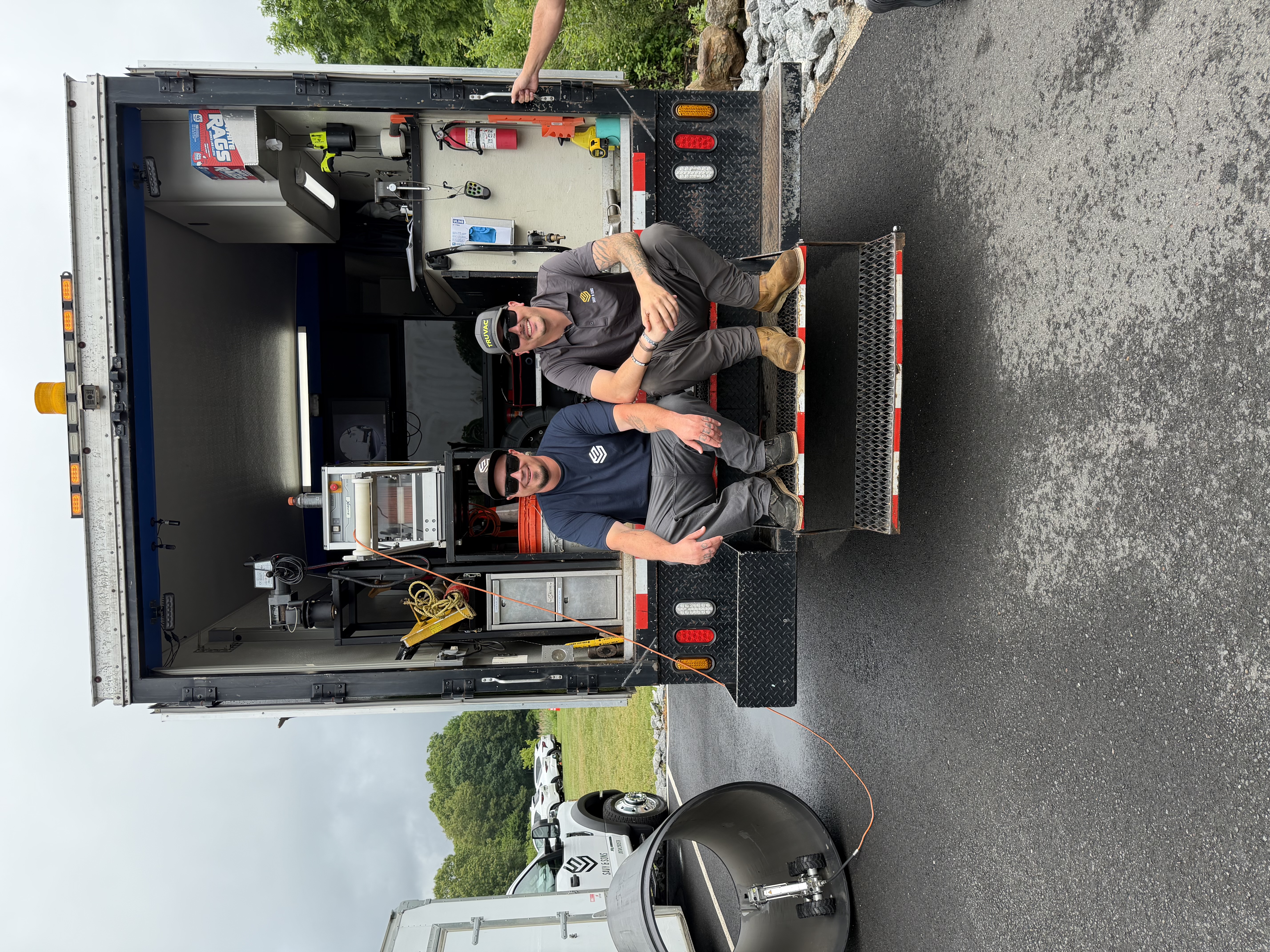 Savy & Sons technicians at the back of a fully equipped field service truck